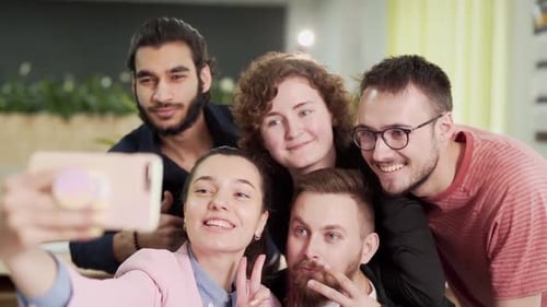 Group of young office workers taking a selfie on the phone