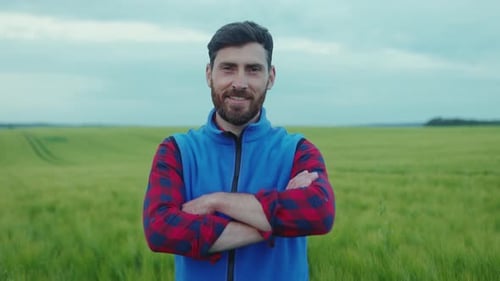 Close Up Portrait of Farmer Man with Beard Looking to Camera Smile Happy in Field Harvesting Organic
