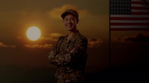 Smiling Soldier Poses with American Flag at Sunset