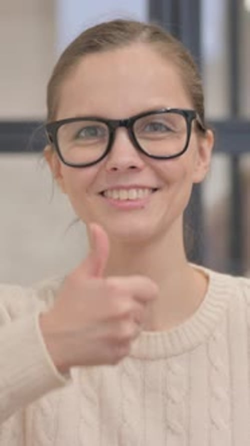 Smiling Woman Giving a Thumbs Up