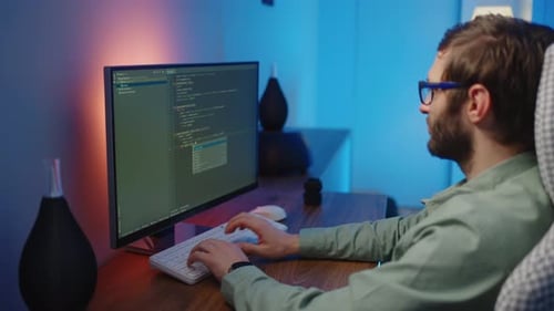 The View From the Back of the Programmer at Work Can Be Seen As the Fingers Type the Code on the