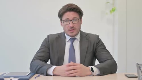 Online Video Chat by Talking Middle Aged Businessman in Office