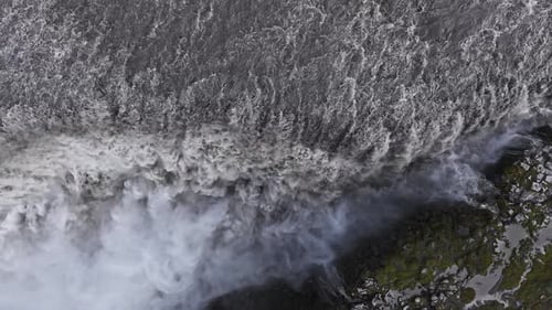 Aerial View of Dettifoss Waterfall Cascading Over Rocky Cliff in Iceland