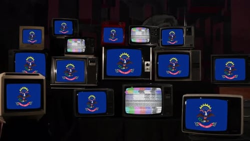 Pile of Vintage Televisions Displaying Static and State Flag