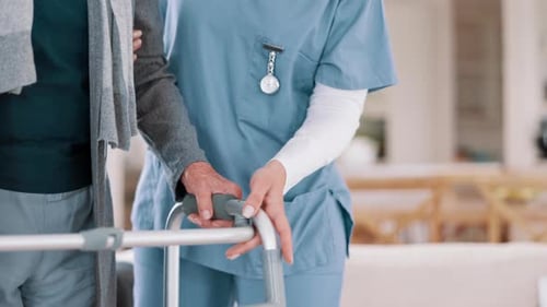 Caregiver Helping Senior Adult with Walker