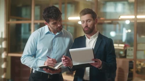 Businessmen Discussing Plans in Modern Workplace