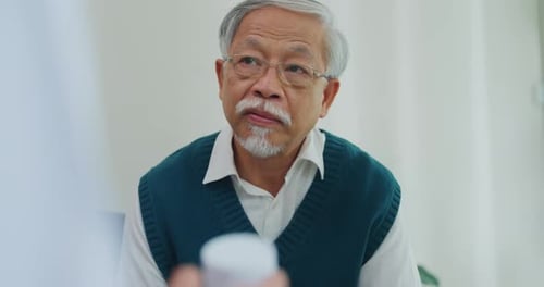 Senior Man Consulting with Doctor in Hospital Setting