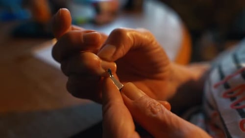 Using scissorsSelfCare Routine Watch As the Older Woman Meticulously Trims Her Nails at Home Using a