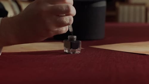 Person Writes with Quill and Ink on Parchment