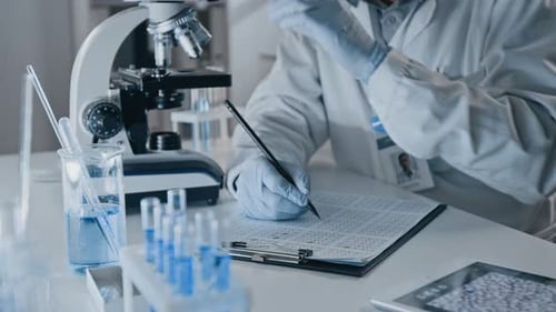 Scientist Working with Microscope in Lab