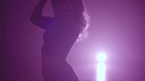 Woman Dancing in Pink Lit Studio