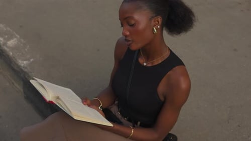 Woman Reading and Laughing on a City Step