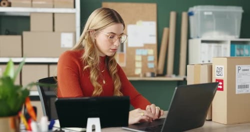 Woman Working on Laptop at Desk in Office