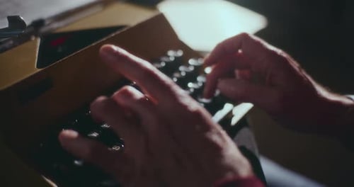 Hands Typing on a Classic Typewriter
