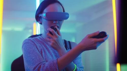 Woman with VR Headset and Controllers in Home