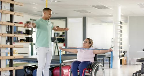 Physical Therapist Working with Woman in Wheelchair