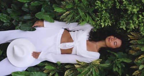 Fashion Tropical Portrait of Young Woman in the Jungle Among Exotic Plants