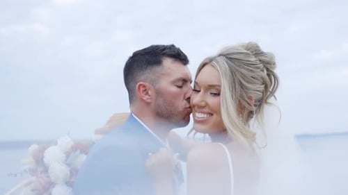 Stunning couple sharing a passionate kiss at golden hour on the beach