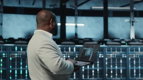 Programmer in Data Center Using Laptop Employing AI Machine Learning Models