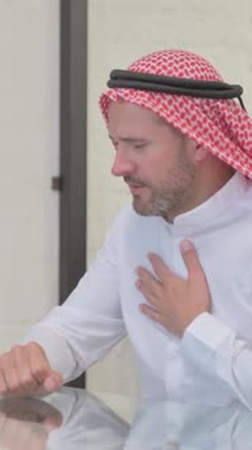 Man in Traditional Headwear Coughing