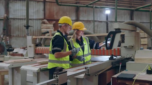 Caucasian Workers Collaborating in Industrial Workshop