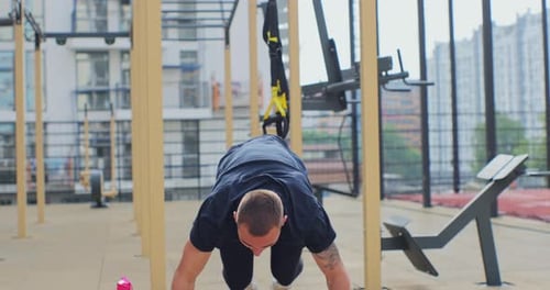 Man Exercising Doing Burpees and Push-ups at Outdoor Gym