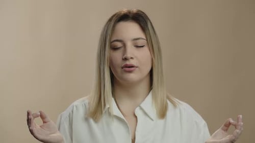 Woman Meditating Indoors for Mindfulness and Wellness