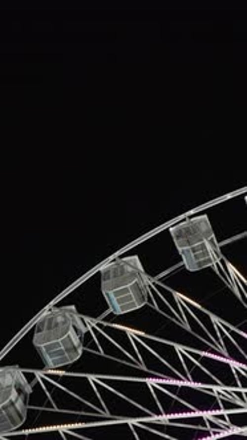Ferris Wheel Rotating at Night in a City