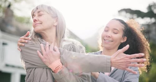 Woman Stretching with Support from Young Adult Friend