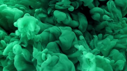 Vibrant green ink drops in water abstract background