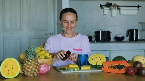 Cheerful Woman Taking Pill After Eating Fruits