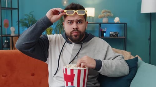 Man Eating Popcorn and Watching 3D Movie