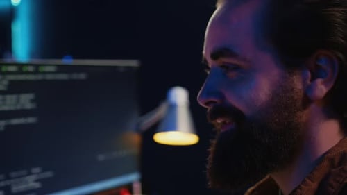 Upbeat Teleworking IT Professional in Apartment Writing Lines of Code Close Up