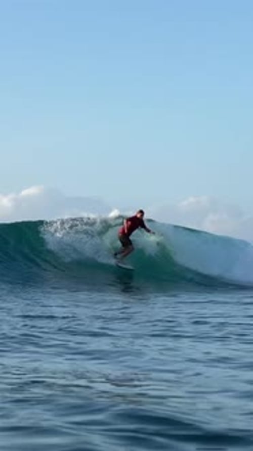Young Guy Surfs in the Ocean