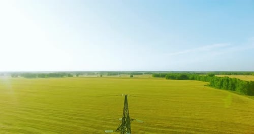Vertical Movement Flight Near High Voltage Electricity Tower and Power Lines at Green and Yellow