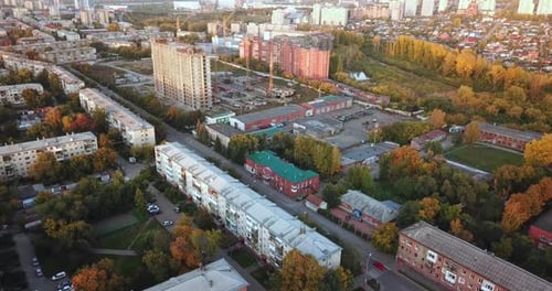 Drone view of residential district in small city at post-Soviet space. Autumn urban landscape.