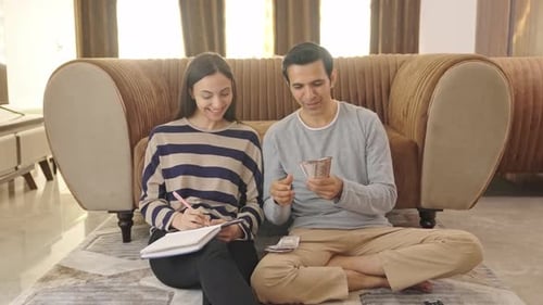 Happy Indian couple counting money