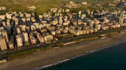 Aerial View A Luxurious Villa Complex on the Seafront Boasts a Sparkling Pool and Vibrant Palm Trees