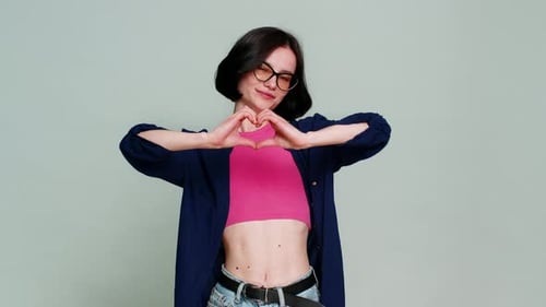 Young Woman Making Heart Shape With Her Hands