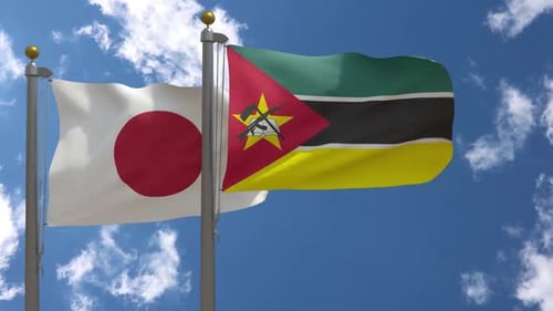 Japan and Mozambique National Flags Waving On A Blue Sky