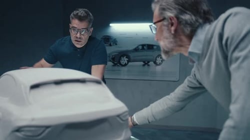 Car Designers Analyzing Prototype Model in Office