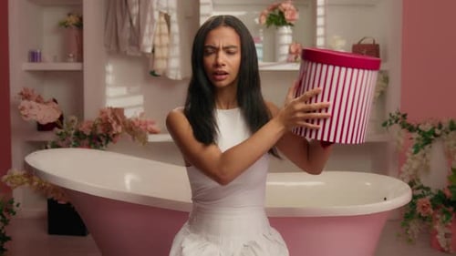 Curious Hispanic Woman Holding Shaking Gift Box Listening Noise Parcel Puzzled Shake Purchase