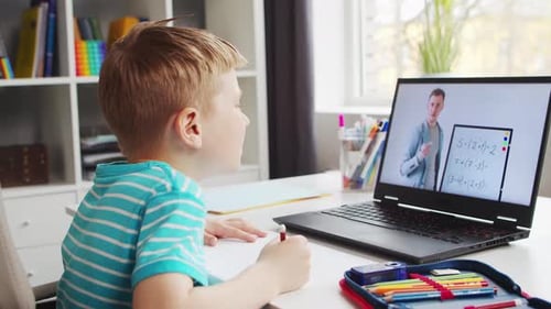 Boy Engaged in Online Tutoring at Home