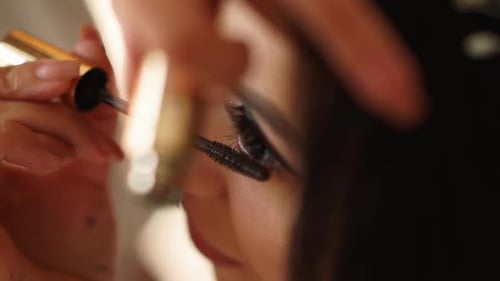 Woman Receives Mascara Application in Close Up Shot