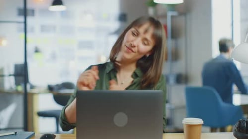 Young Beautiful Brunette Works on a Laptop Computer in Cool Creative Agency in a Loft Office. She i