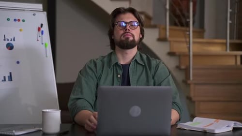 Young Businessman Working with Laptop and Having Break While Sitting at Table in Home Office Spbas