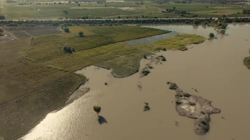 Floodwaters engulfing agricultural land in Punjab, Pakistan, causing widespread devastation