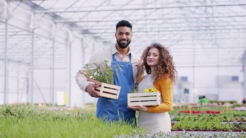Colleagues Working in Garden Centre, Looking at Camera