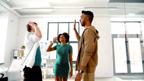 Team Building Success High Five in Modern Office