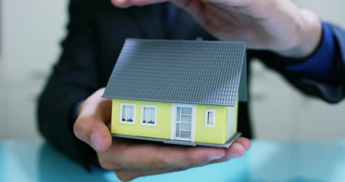insurance of fire and theft .the hands of an insurer or real estate agent showing a house with fl